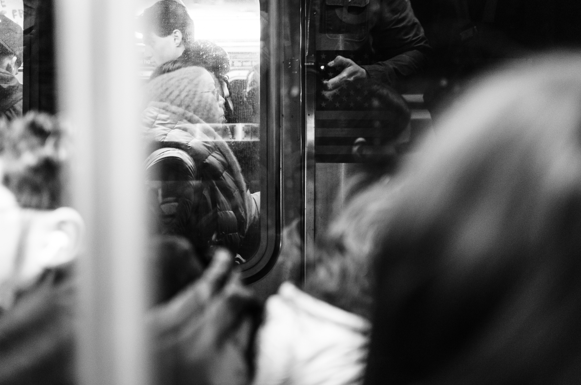 View from one packed subway car into the next